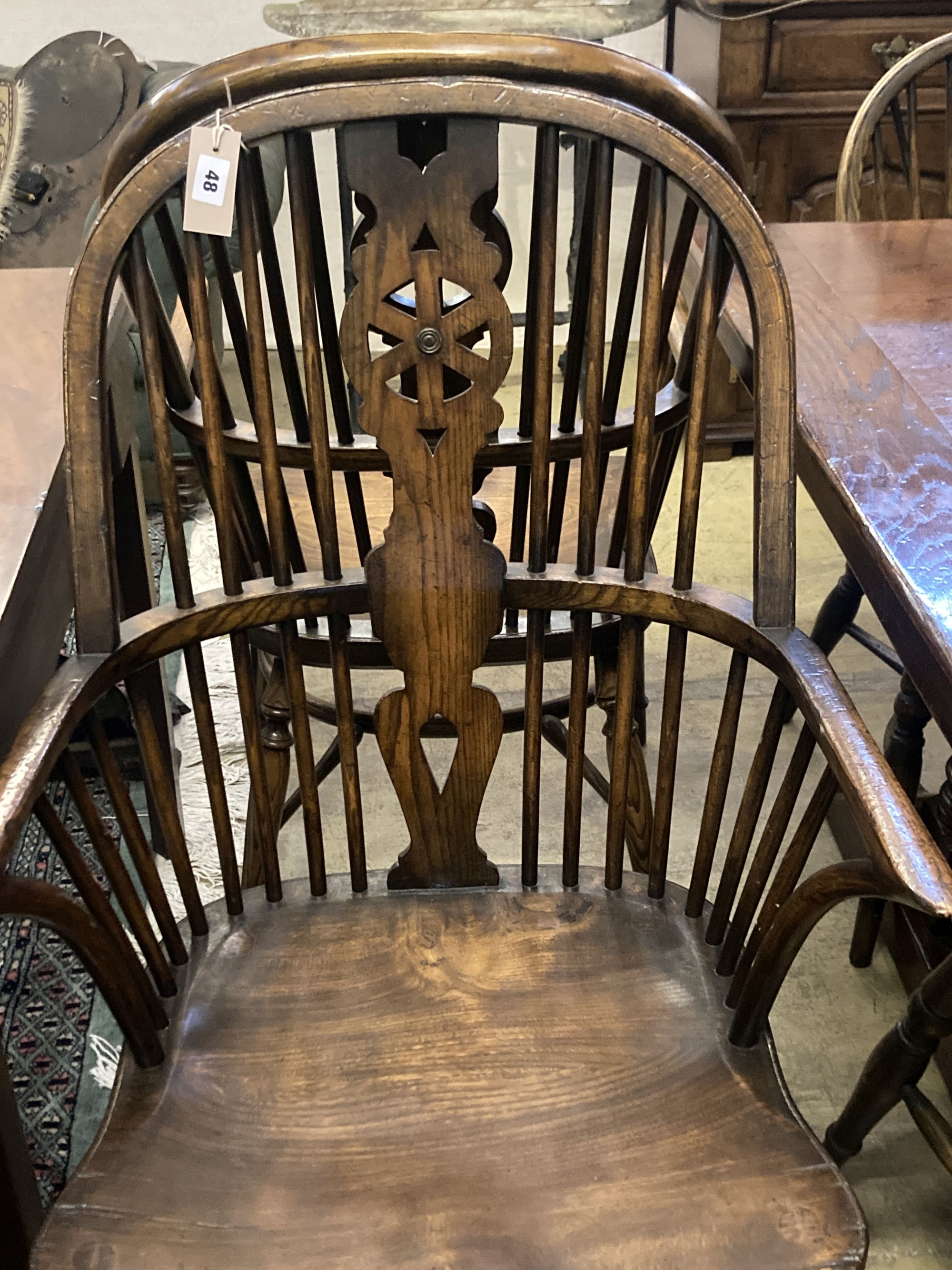 A set of ten stained ash and elm Windsor chairs with crinoline stretchers (two having arms)